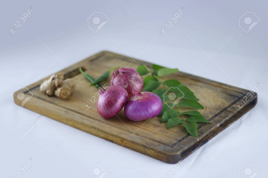 136120285-fresh-ingredients-for-cooking-with-onions-ginger-and-curry-leaves